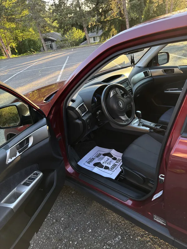 Clean driver seat of a red Subaru Forester after a detail
